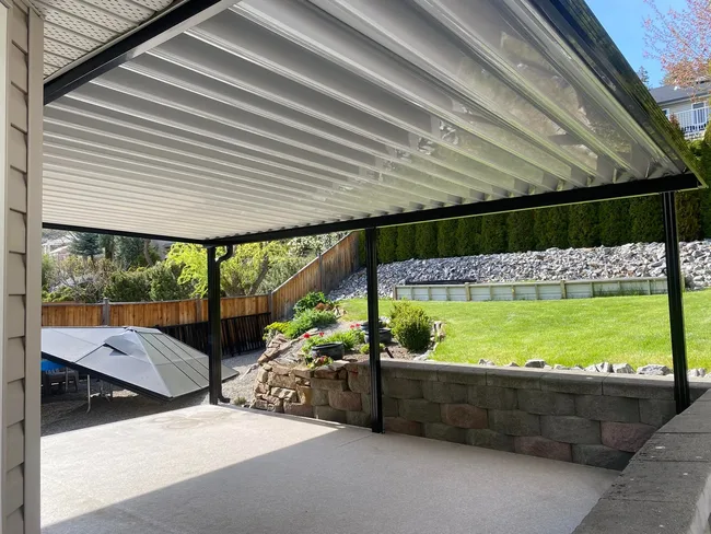 White aluminum patio cover with garden view in Kelowna