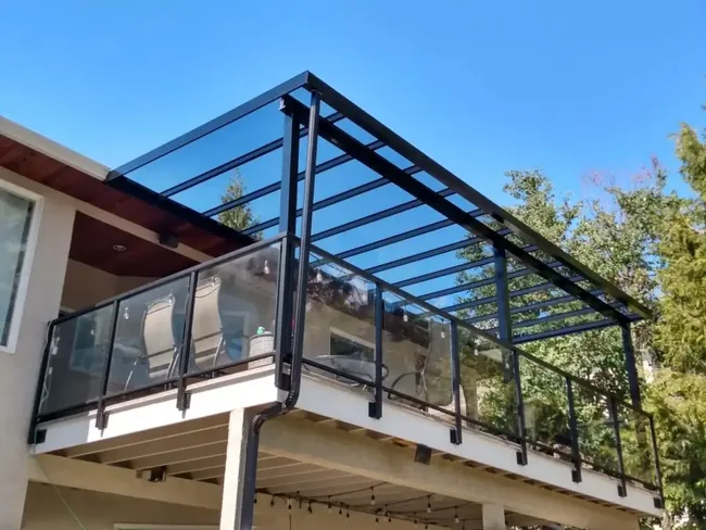Glass roof patio cover over a balcony in Kelowna