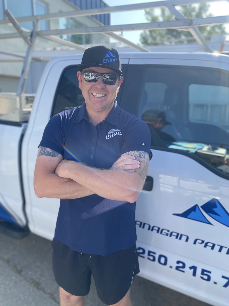 Owner of Okanagan Patio Covers standing by the company truck
